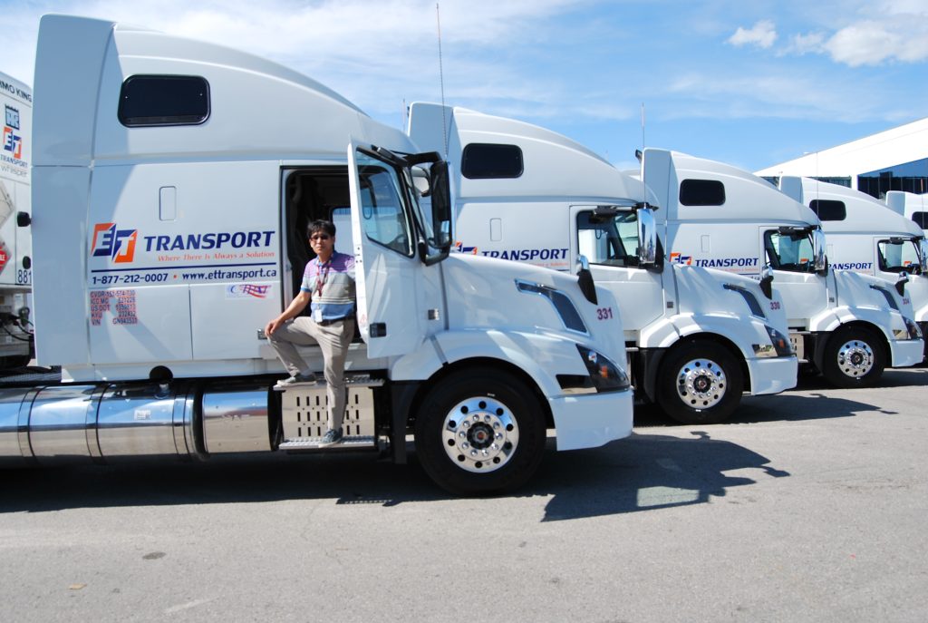 Fleet of freight trucks parked in a lot, ready for transportation or logistics operations