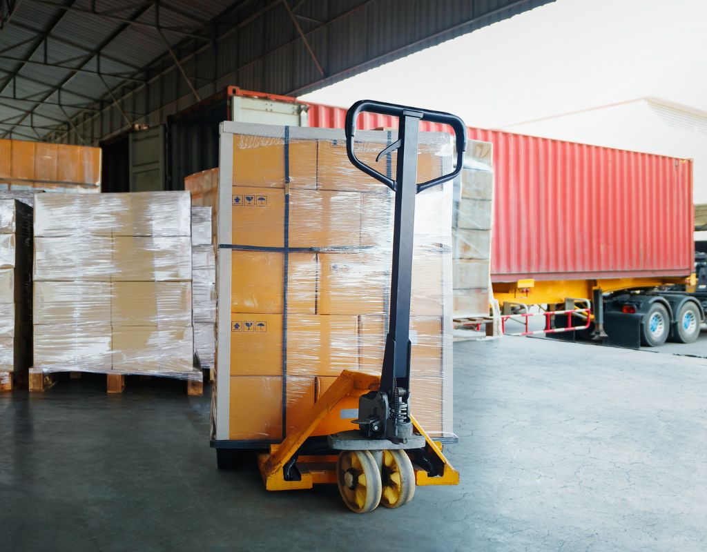 Forklift unloading freight from shipping container for inventory sorting